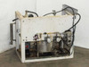 Rear view of lacquer dispensing system showing stainless containers, manifold plumbing, electrical connections, and frame structure