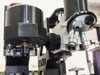 Nano Instruments indenter head and Olympus BH2-UMA microscope column close-up — MDPLAN objectives visible on turret, indenter body with NANO label