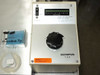 Olympus TGH illumination controller front panel close-up — ON/OFF power switch, LED voltage bar display (2-12V), and OLYMPUS TGH label; nanoindenter tip case visible at left
