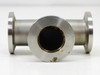 KF25 NW25 stainless tee vacuum fitting — front-on view into one port showing bore interior and brass-toned O-ring seat; light surface staining on flange face