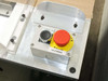 Uni-Solar MX1-711-000-5 — close-up of control panel showing Power On pushbutton and red mushroom emergency stop with PARO DE EMERGENCIA label