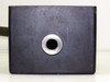 Edwards vibration isolation block — black anodized aluminum body with single circular port opening, front face view