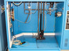 Interior lower cabinet view showing gas manifold plumbing, stainless tubing, fittings, and Funak pump assembly