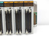 Three NAIS FP2-Y64T 64-point NPN transistor output modules closeup — showing Tr(NPN) 0.1A 5-24V markings, CN1/CN2 ribbon connectors