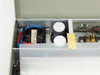 Interior view of LCD Co fluorescent light box showing transformer and capacitors in left compartment of electronics bay