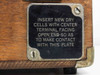 Close-up of battery compartment instruction plate on Winslow Co Type 301 case side — reads 'Insert new dry cells with center terminal facing open end'