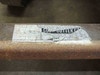 Close-up of weathered Cost Cutter brand label on rusted steel frame rail of delivery cart