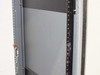 Side interior view of rackmount cabinet showing square-hole rack rail column, side panel, and chain latch hardware