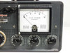 Simpson 498-A — close-up of analog field strength meter face calibrated in microvolts with battery voltage scale at top, and lower control panel showing Signal Level–Microvolts, Channel Calibration, Power, and Battery/AC charge selector knobs