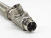 Close-up of 90-degree elbow end showing two NPT ports and inner bore with clean threads