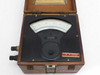 Close-up of meter face showing VOLTS arc scale, Sensitive Research Electrostatic Voltmeter label, and asset tag ID 415054 on black front panel