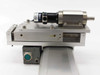 Close-up of Yamaha linear slide carriage end showing Sanyo Denki L404 motor, gearhead, shaft output, and 19-pin circular connector with M12 connector below