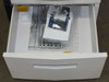 Kyocera Mita FS-9500DN lower pedestal drawer open — contains accessory packet in plastic bag