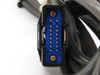 Close-up of second blue D-sub style multi-pin connector end on interconnect cable — pin detail visible