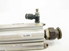 SMC compact pneumatic cylinder – end view detail showing single push-to-connect elbow fitting and threaded rod end