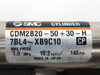 SMC CDM2B20-50+30-H cylinder label closeup showing model number, 7BL4-XB9C10, 1.0 MPa 145 PSI max pressure, Made in Japan