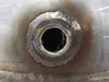Close-up of 1/2 inch FNPT mid-flange port weld on reducer body showing heavy oxidation and weld bead around fitting