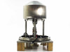 DSM vibratory hopper feeder rear view showing stainless dome hopper, column supports, base platform, and wiring