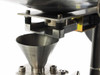 Stainless steel conical discharge funnel below the hopper outlet showing lower port and mounting hardware
