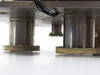 Underside view of base showing three cylindrical support legs with rubber/felt feet pads and wiring
