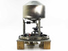 DSM vibratory hopper feeder front view showing stainless steel dome hopper, support columns, vibrating platform, and wooden base
