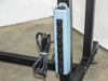 6-outlet blue power strip mounted to table leg frame, with coiled power cord — side view