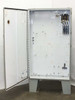 Hammond 1418 T12 enclosure interior – door open showing large white backplate with mounting knockouts, 3-pole disconnect assembly upper right, terminal block lower right