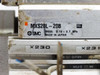 SMC MXS20L-20B label closeup showing model number, SMC logo, operating pressure 0.15–0.7 MPa, and Made in Japan marking