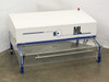 SLEE VLF/M 500-1000 HEPA laminar flow hood – front three-quarter view showing Singulus Technologies branding, white enclosure, red indicator light, and clear acrylic work table with blue support legs