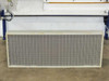 Second AAF AstroCel HEPA filter panel — front mesh face view with orange border frame, removed and resting on floor below the hood