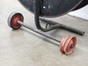 Signode DD-1A dispenser — base axle detail showing red metal wheels with surface rust and wear