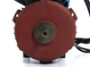 ATB motor rear fan end — circular red fan cover viewed straight on, central shaft opening visible, surface wear and rust on fan cover