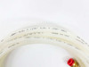 Close-up of included Nylon 11 water cooling tubing markings — 0.250 inch OD x 0.170 inch ID x 0.040 inch wall, 330 PSI rated, Made in USA, with brass push-in fitting