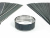 Solopower CIGS flexible solar cells lot of 100 — fan arrangement with one cell coiled into a ring showing flexibility, stainless steel substrate visible