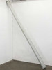 Draper LUMA2 projection screen in white aluminum housing, leaning against wall — full length side view