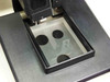 Sloan Dektak IIA scan head stage — top-down view of sample stage showing four circular magnetic sample holders on glass/mirror stage surface