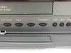 Go Video GV-6060 lower control panel close-up — Fast Forward, Pause, Record, Deck Select, Clear, Menu, Select buttons visible