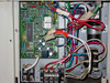 Mitsubishi Electric PU18EK internal control board close-up showing PCB, wiring harness, and L1 L2 GR terminal block