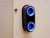 Refrigerant line port grommet on air handler panel — dual blue-capped fittings, close-up view