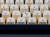 Close-up of center keyboard showing depressed BELL/G key sitting lower than surrounding keys