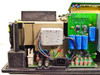 Beckman DU-65 internal close-up of EMI line filter, IEC inlet, power supply PCB, and blue electrolytic capacitors