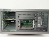 HP ProLiant ML370 front panel view with side panel removed showing empty hot-swap drive bays, CD-R drive, and floppy bay