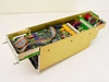 APC MAA-0852 enclosure interior — top-down angled view showing full length of main PCB with ICs, relays, ribbon cables, and gold metal chassis