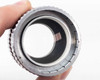 Simpson Optical Perceptordaptor 137-0001 — front face view held in hand showing internal optical element and threaded inner ring