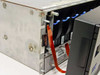 IBM 7133-D40 interior side view showing SSA hard drive modules with blue pull tabs and ribbon cables