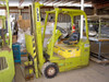 Clark TW30B forklift — right three-quarter view showing operator seat, steering wheel, overhead guard, and forks