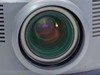 InFocus LP1200 projection lens close-up showing multi-element glass lens assembly