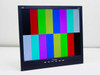 ViewSonic VA912b 19in LCD monitor powered on displaying color bar test pattern — three-quarter front-left view, no base