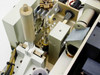 Interior view of arc lamp housing showing UXL-S150M0 lamp, lamp carriage clamp, and adjacent linear stage components