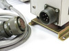 Close-up of ACT lamp housing rear showing male MS3102A18-11P circular connector and interconnect cable plug